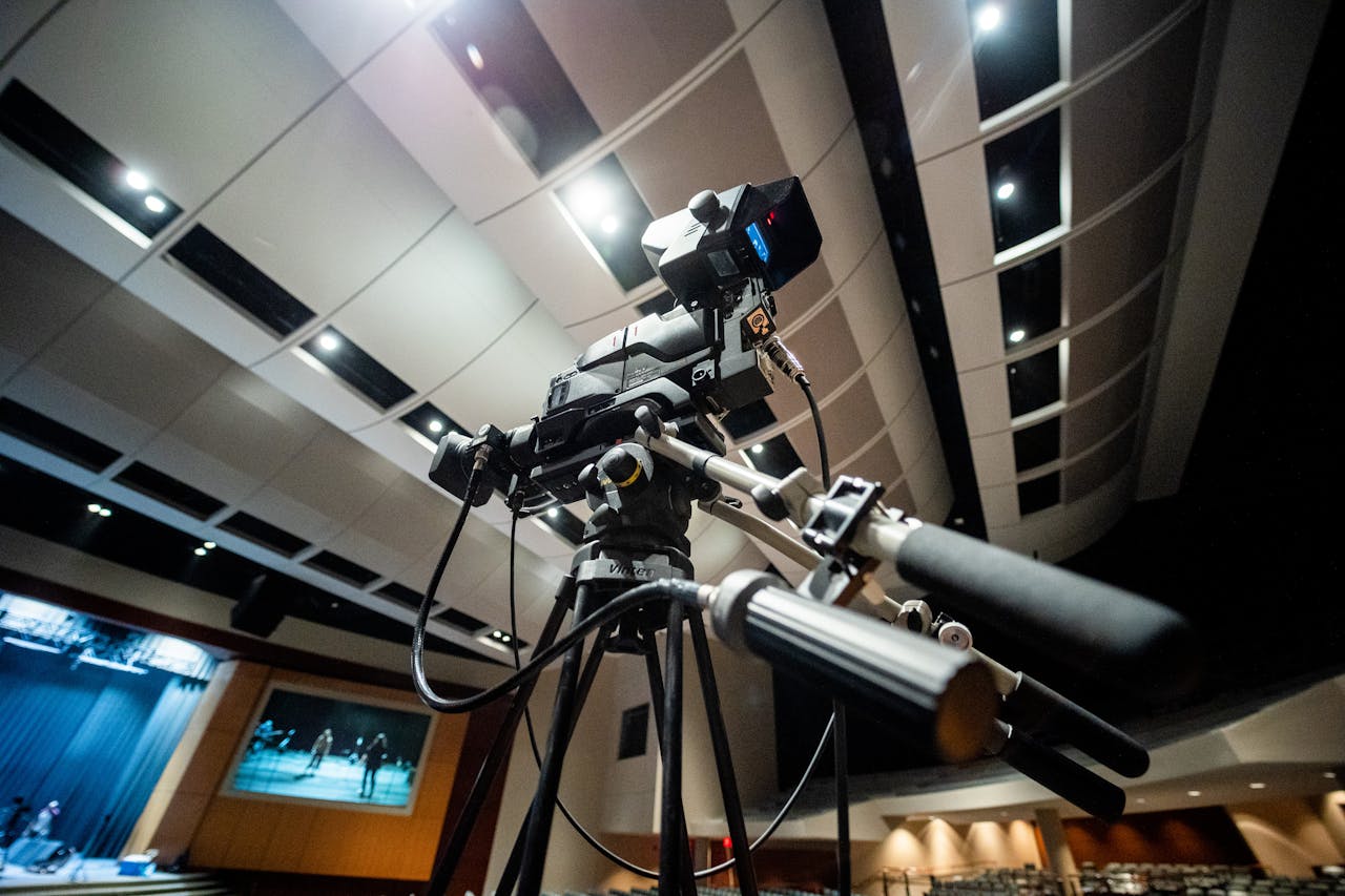 our-journey-03 Professional video camera setup in a theater capturing a performance, showcasing modern filming technology.